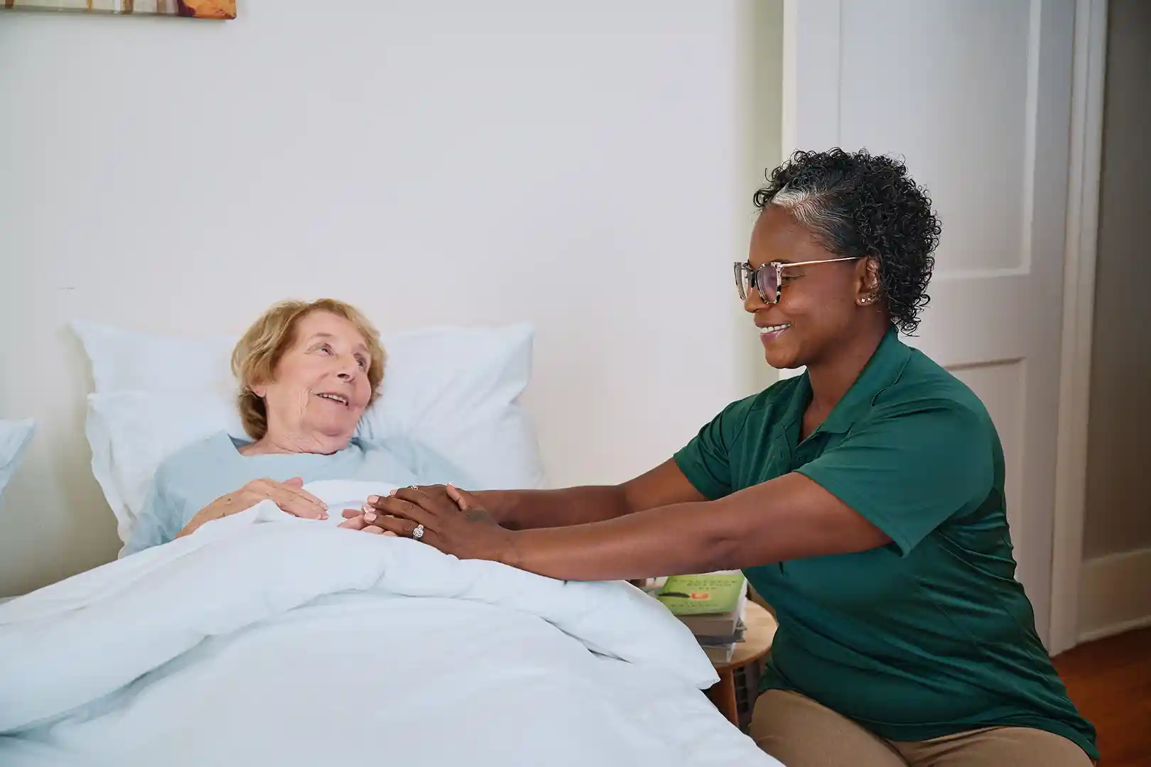 Care Pro providing nighttime reassurance and bedtime support to senior woman in Toronto home