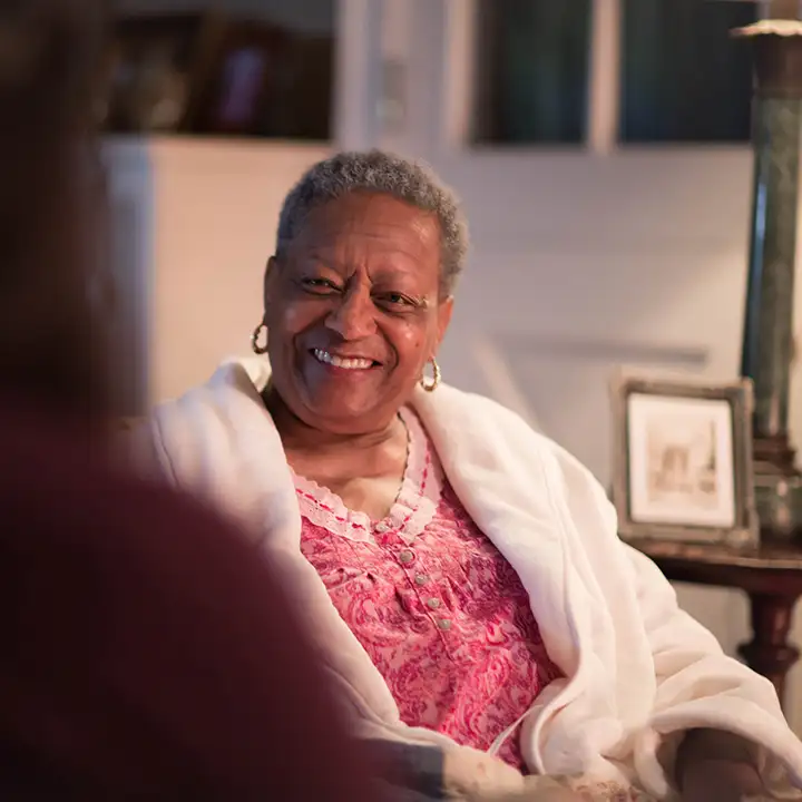 Senior sitting in pajamas